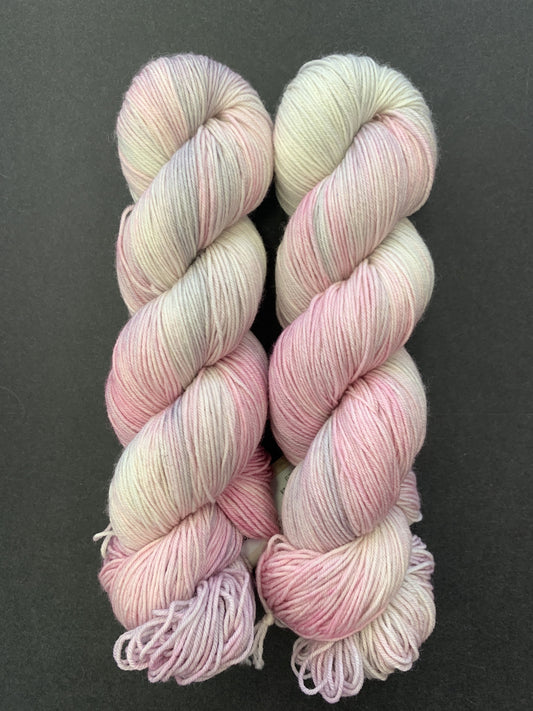 This Merino wool yarn is multi colored yarn by Forbidden Fiber Co.  This is a superwash yarn with beautiful variegated colors.  Inspired by Glinda (the good witch) , these colors will make anyone a "good witch". 